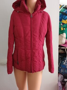 Vibrant red hooded puffer jacket  vertical quilted seaming and a convenient full